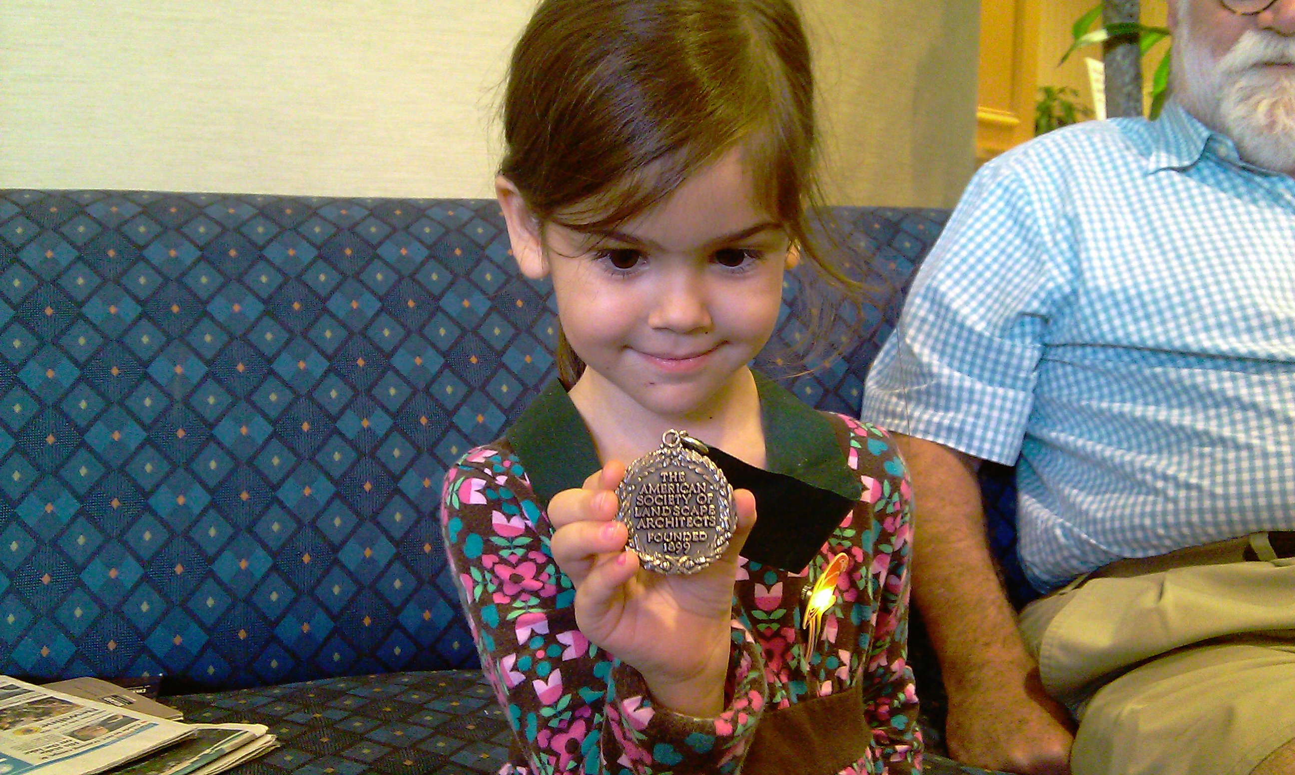 My daughter trying on Ted Baker's Fellows medal at the Gainesville Conference